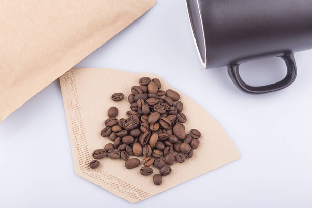 Kaffeebohne mit Kaffeepapierfilter auf weißem Hintergrund - Foto, Bild