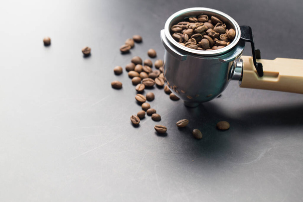 Coffee beans and porta filter with ground coffee - Fotoğraf, Görsel