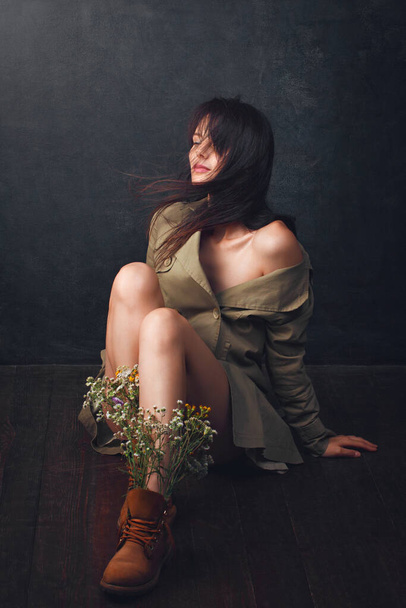 Portrait of an attractive girl. Wild flowers in shoes. - Photo, Image