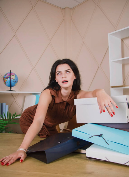 Girl in the office takes out boxes with documents - Fotó, kép