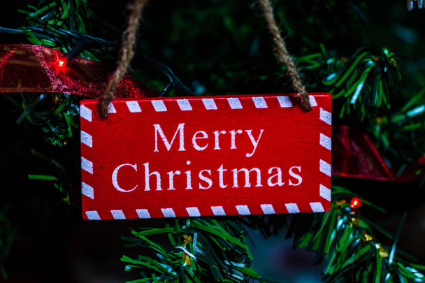 Merry Christmas text wooden sign, decorations and ornaments in a colorful Christmas composition. - 写真・画像
