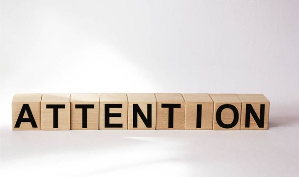 Attention word consisting of building blocks on white background - Foto, afbeelding
