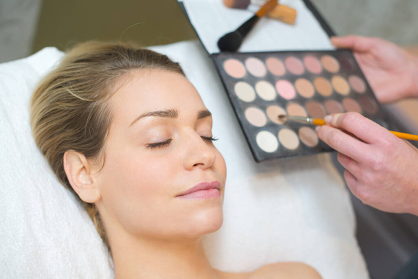 make-up artist applying the mascara to model - Photo, image