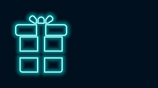 Zářící neonová čára Ikona dárkové krabice izolované na černém pozadí. Grafická animace pohybu videa 4K - Záběry, video