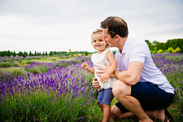 Happy family father and daughter having fun in lavender field - Fotoğraf, Görsel