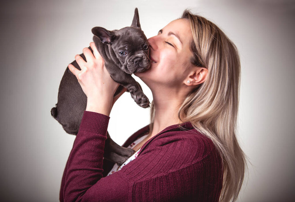 Beautiful woman with french bulldog on studio - Zdjęcie, obraz