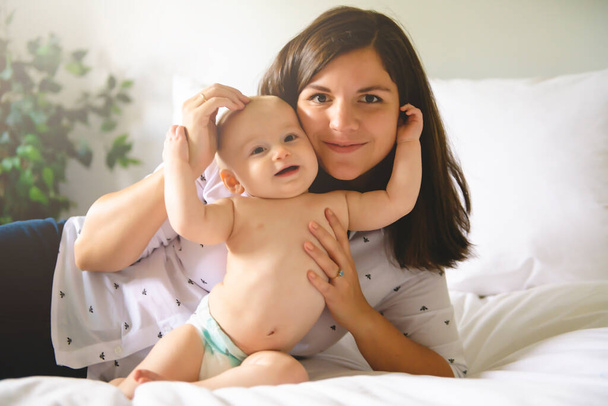 A Mother and baby on bed having fun - Photo, Image