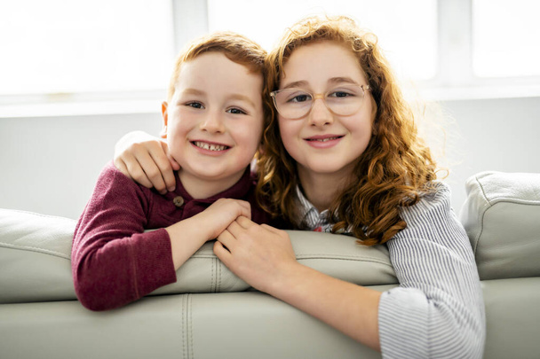 Happy girl and boy watching tv at home - Foto, Imagen