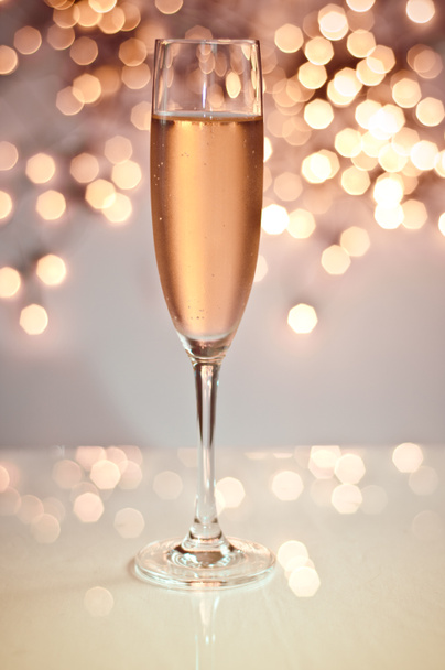 Glass of champagne against golden background - Photo, Image