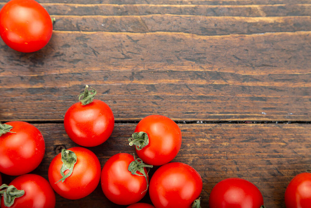 Ripe tomatoes on a wooden background. Harvesting concept. Vegetarian food. Space fot text. - Фото, зображення