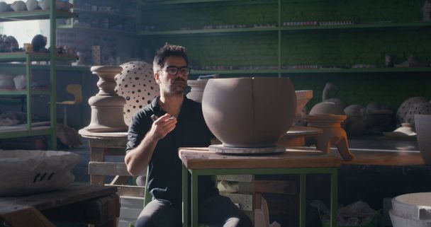Potter creating ornament on clay bowl - Photo, Image