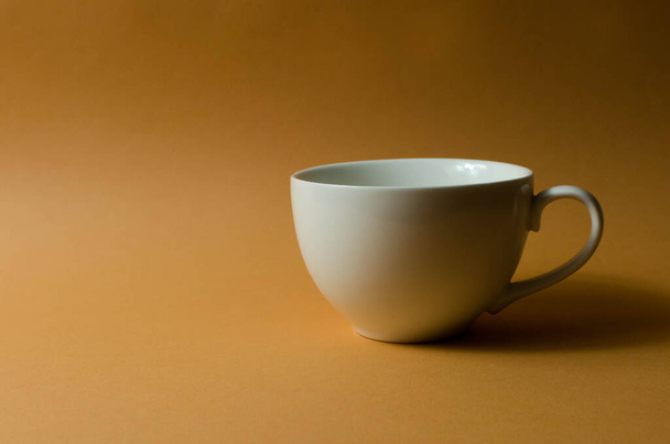 Керамический кубок и чайник на столе - Фото, изображение