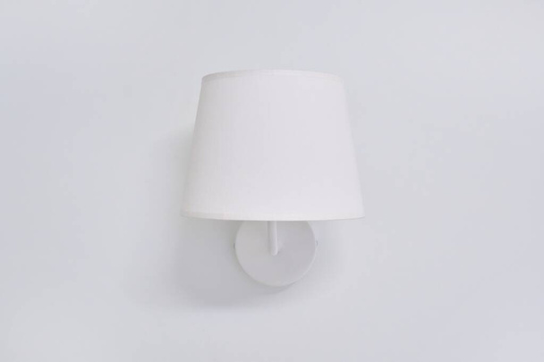 White elegant modern wall lamp with textile shade in interior - Foto, Imagen