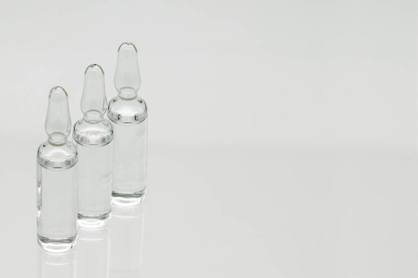 Glass ampoules with liquid, isolated on white background. - Valokuva, kuva