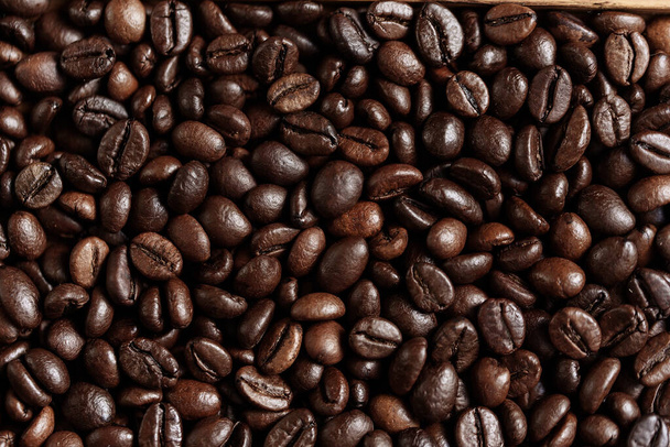 closeup of perfect Roasted coffee beans background. Food ingredients, top view, space for text. Soft selective focus. Cappuccino, aroma black caffeine drink ingredient for coffee beverage. Coffee Shop - Photo, Image
