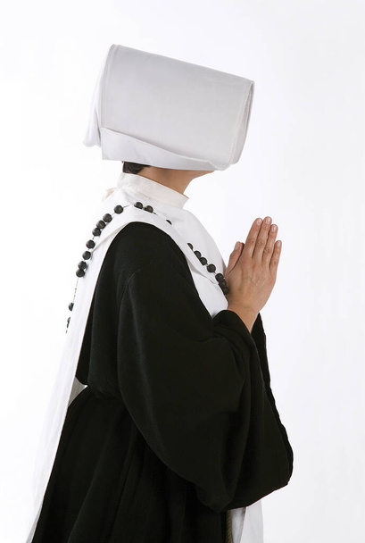 Nun standing and praying. White background. - Photo, Image