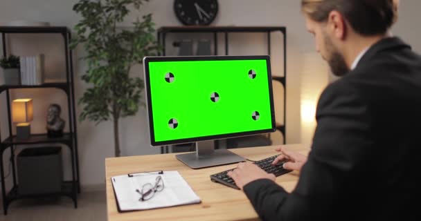 Office man working on computer with green screen - Felvétel, videó