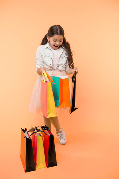 Great strategies to save on back to school purchases. Back to school season teach budgeting basics. Girl carries shopping bags. Prepare for school season buy supplies stationery clothes in advance - Photo, image
