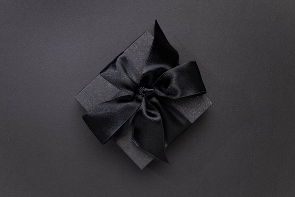 Black gift box on black background for Black Friday concept - Fotoğraf, Görsel