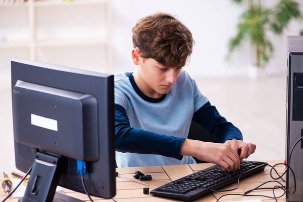 Boy reparing computers at workshop - Photo, Image