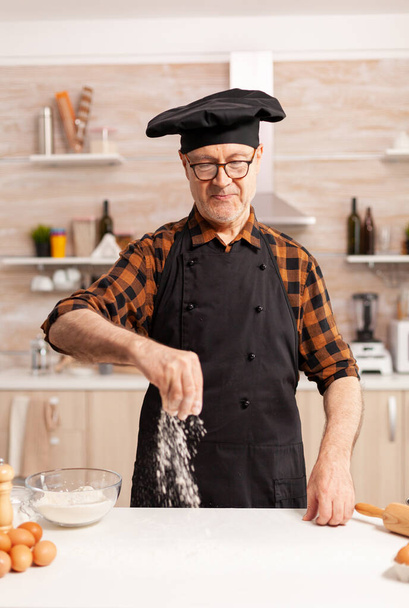 Senior chef in home kitchen - Фото, изображение