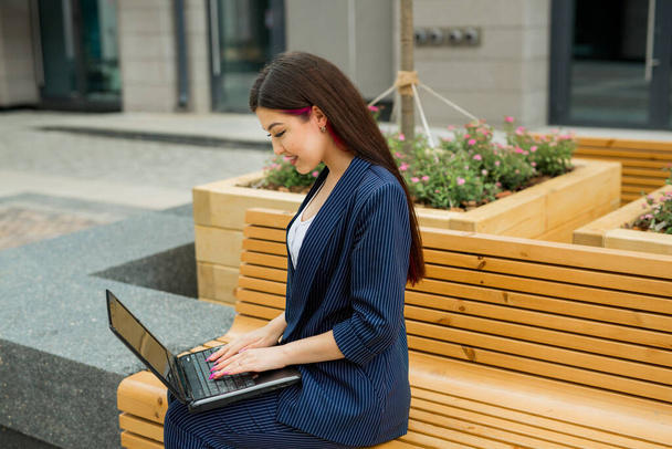 beautiful young woman in suit with laptop - Photo, Image