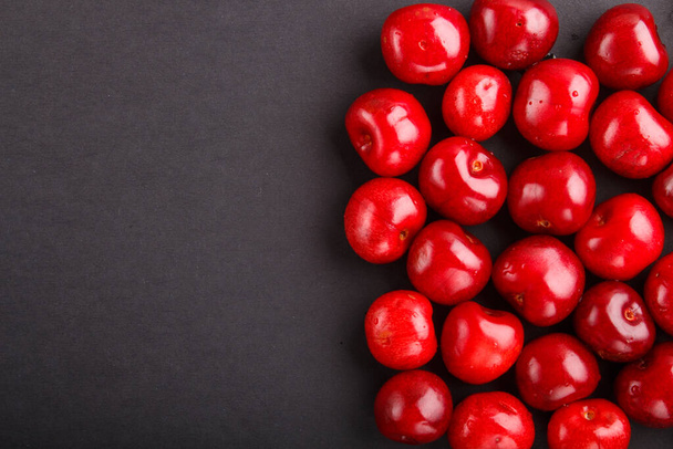 Cherries on black background, top view, flat lay, copy space. - Photo, Image