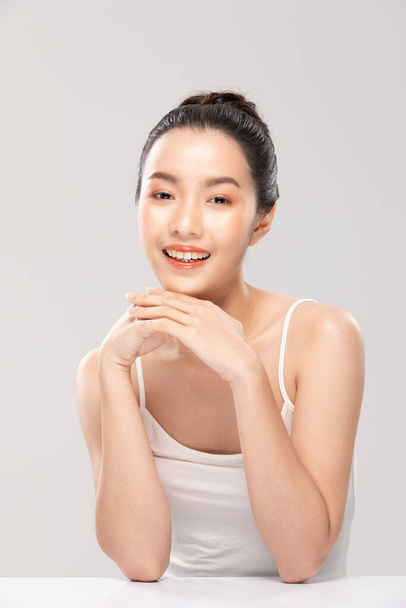 Beautiful Asian young woman touching soft cheek smile with clean and fresh skin Happiness and cheerful with positive emotional,isolated on white background,Beauty and Cosmetics Concept - 写真・画像