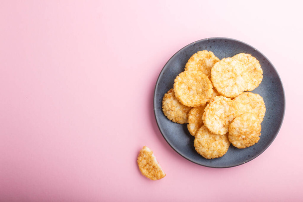 Traditional japanese rice chips cookies with honey and soy sauce on a pastel pink background. Top view, flat lay, copy space. - Valokuva, kuva
