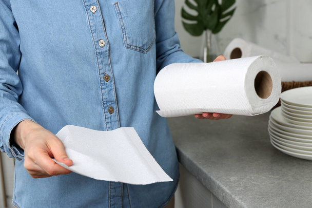 Woman using paper towels in kitchen, closeup - Photo, Image
