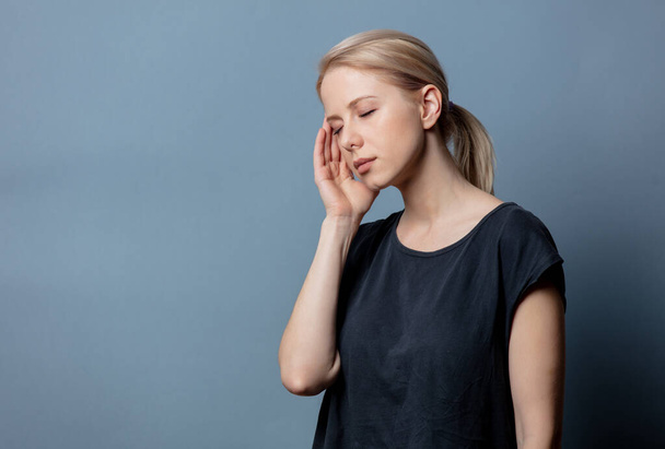 Frau mit Kopfschmerzen auf grauem Hintergrund  - Foto, Bild