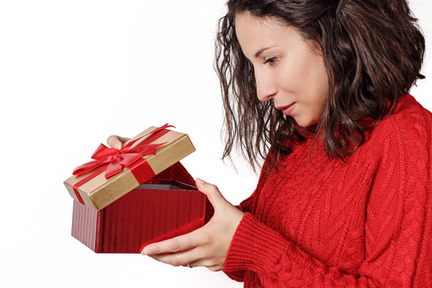 Surprised young woman holding Gifts in hands close up - Photo, image