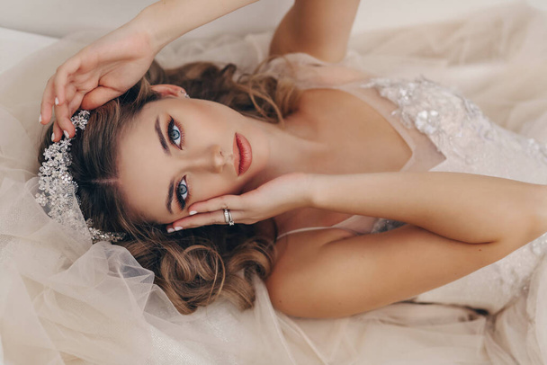 fashion portrait of beautiful bride with blond hair in luxurious wedding dress and accessories - Fotografie, Obrázek
