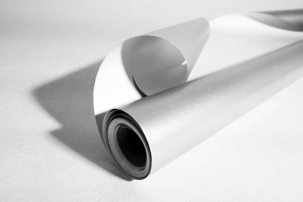 Side view of gray roll paper, black and white photo, selective focus. - Photo, image
