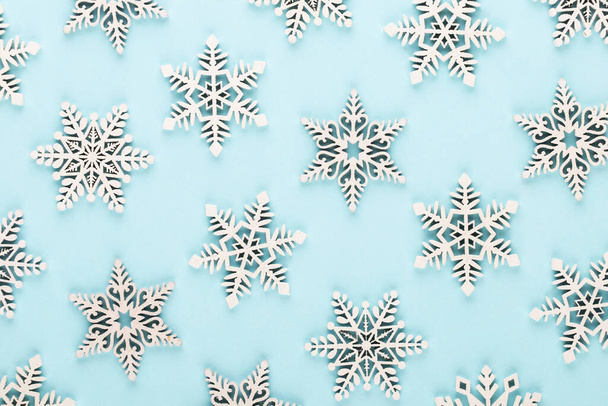 Christmas background. White snow decorations on a pink background. - Photo, Image