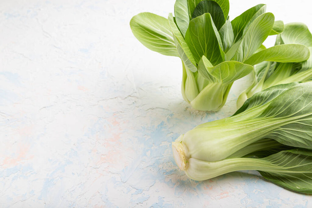 Fresh green bok choy or pac choi chinese cabbage on a white concrete background. Side view, copy space, close up. - Foto, imagen