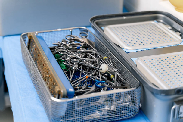 Sterile stainless steel wire in the metal box on the table for use in surgery to orthopedic patient in the operating room. Medical instruments. - 写真・画像