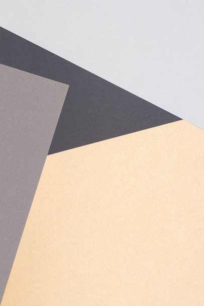 Creative abstract geometric paper background light gray, black colors and brown craft paper. Top view. Copy space - 写真・画像