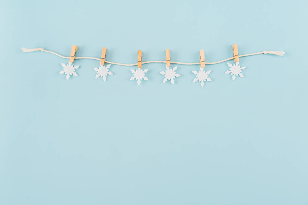 Christmas composition. Snowflakes on blue background. Christmas, winter, new year concept. Minimal style. Flat lay, top view, copy space. - Photo, Image