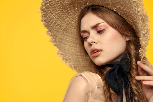 Portrait woman in straw hat on yellow background cropped view of summer dress model pigtails romance - Фото, изображение