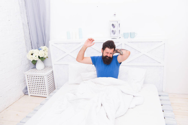 brutal bearded guy has headache early in the morning while laying in bed, healthcare - Foto, Imagen