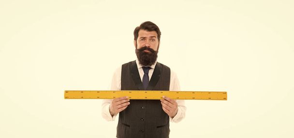 bearded man with ruler isolated on white. Measuring his height with ruler. university teacher hold ruler. size and length measurement. school stem disciplines. back to school. Measuring his beard - Foto, afbeelding
