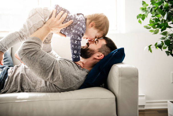 A Father And Son Playing On the living room Together - Foto, afbeelding