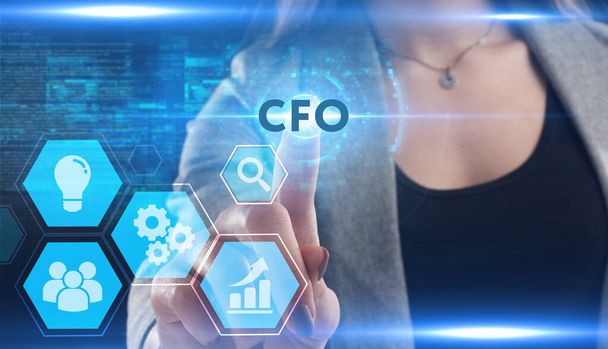 Business, Technology, Internet and network concept. Young businessman working on a virtual screen of the future and sees the inscription: CFO - Photo, image