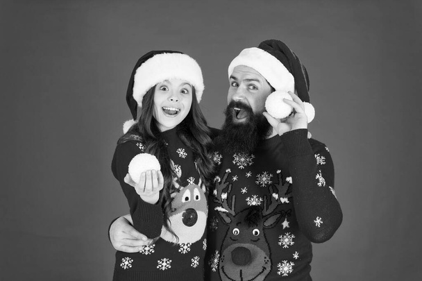 We are family. family holiday fun. small girl and dad red background. merry christmas everyone. Greeting xmas tradition. happy family play snowballs in winter. father and daughter celebrate new year - Фото, зображення