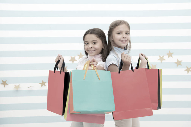 Dream of every girl shopping together with best friend. Girls children best friends hold bunch of shopping bags. Seasonal sale and discount. Possible to buy happiness. Friends sisters happy with bags - Photo, Image
