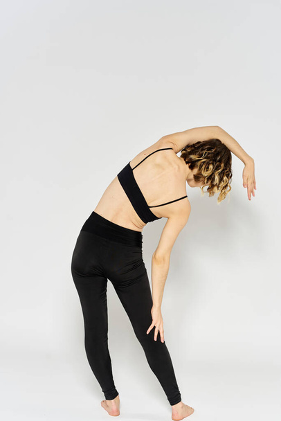 Yoga asana sport woman fitness light background leggings model - Foto, afbeelding