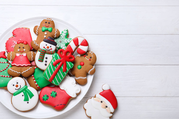 Delicious Christmas cookies on white wooden table, flat lay. Space for text - Zdjęcie, obraz