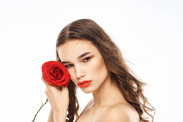 Woman with naked shoulders and red rose evening makeup light background - Fotoğraf, Görsel