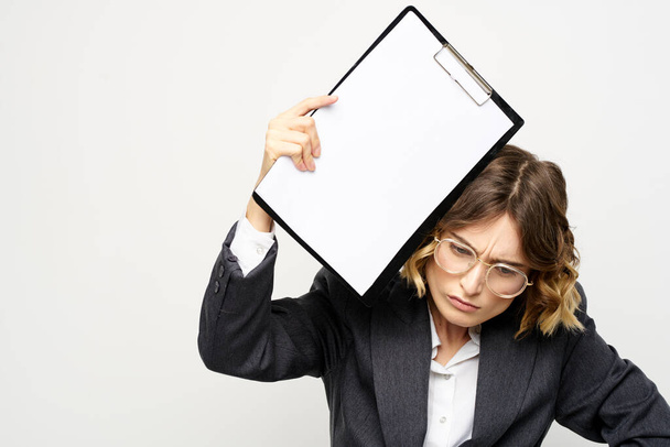 Business woman with a folder of documents on a light background cropped view and shirt suit - Foto, Imagem